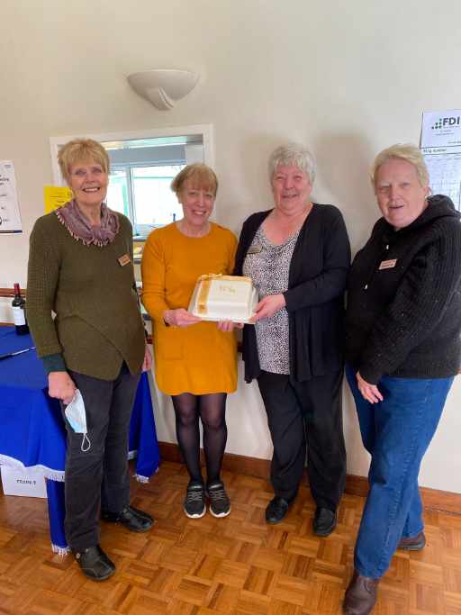 Celebrants with the cake holding the cake